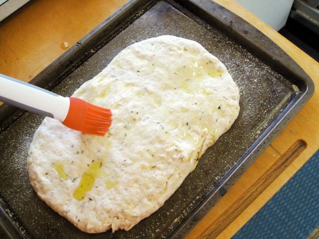Brush the top of the loaf with olive oil